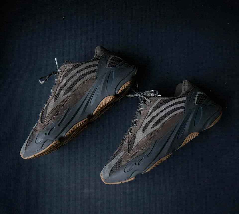Original photo of two gray sneakers against a dark background